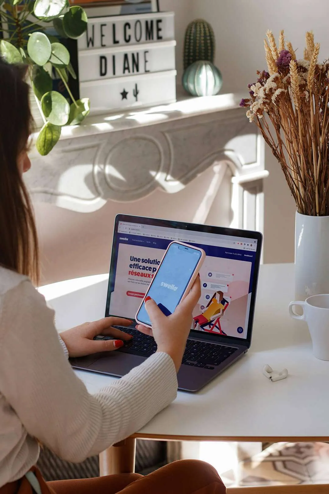 Woman sitting at table using laptop computer to make online purchase